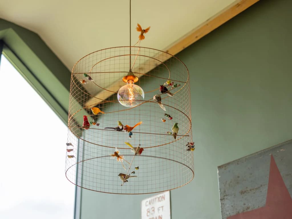 Quirky copper bird-cage pendant light — characterful interiors throughout.