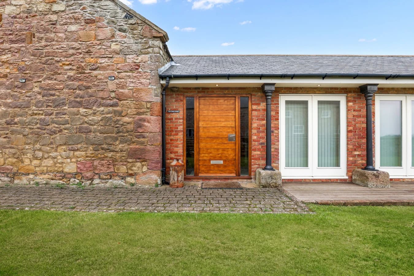 Private entrance with stone façade and timber front door