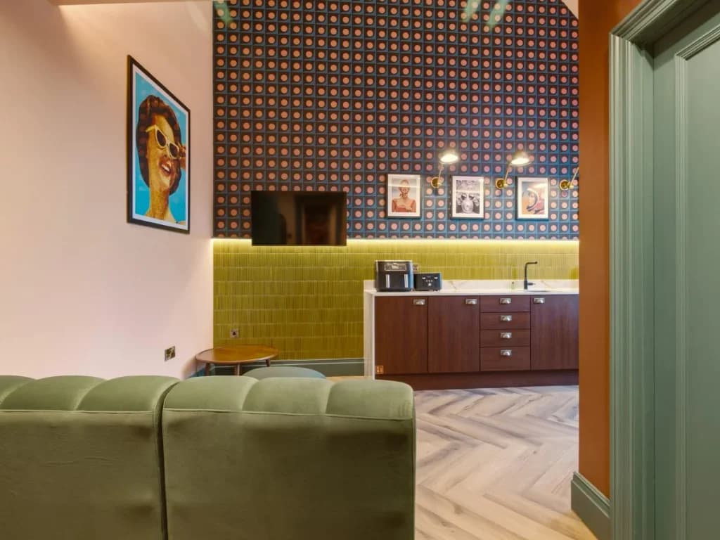 Living area looking towards the patterned feature wall and kitchenette