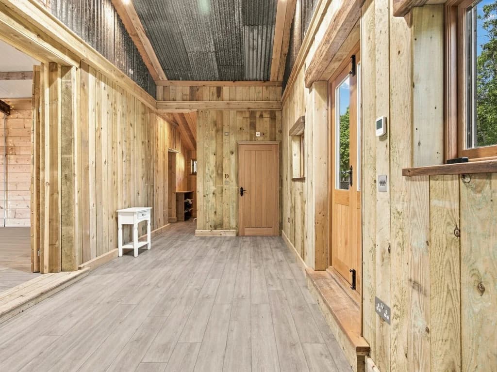 Timber-lined hallway connecting the event space and facilities