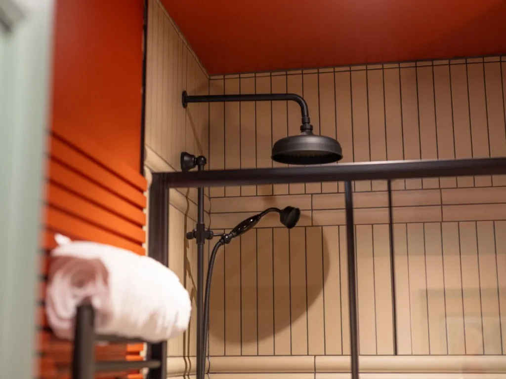 Close-up of the walk-in shower with black rainfall fittings