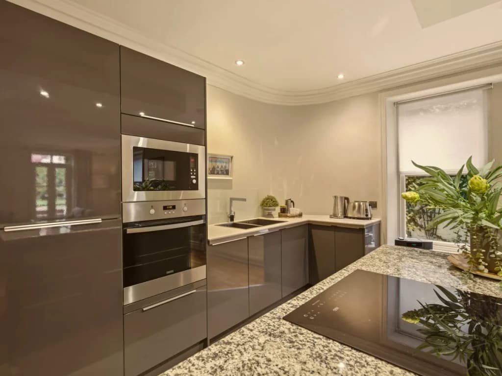 Modern kitchen with dark cabinetry and integrated appliances