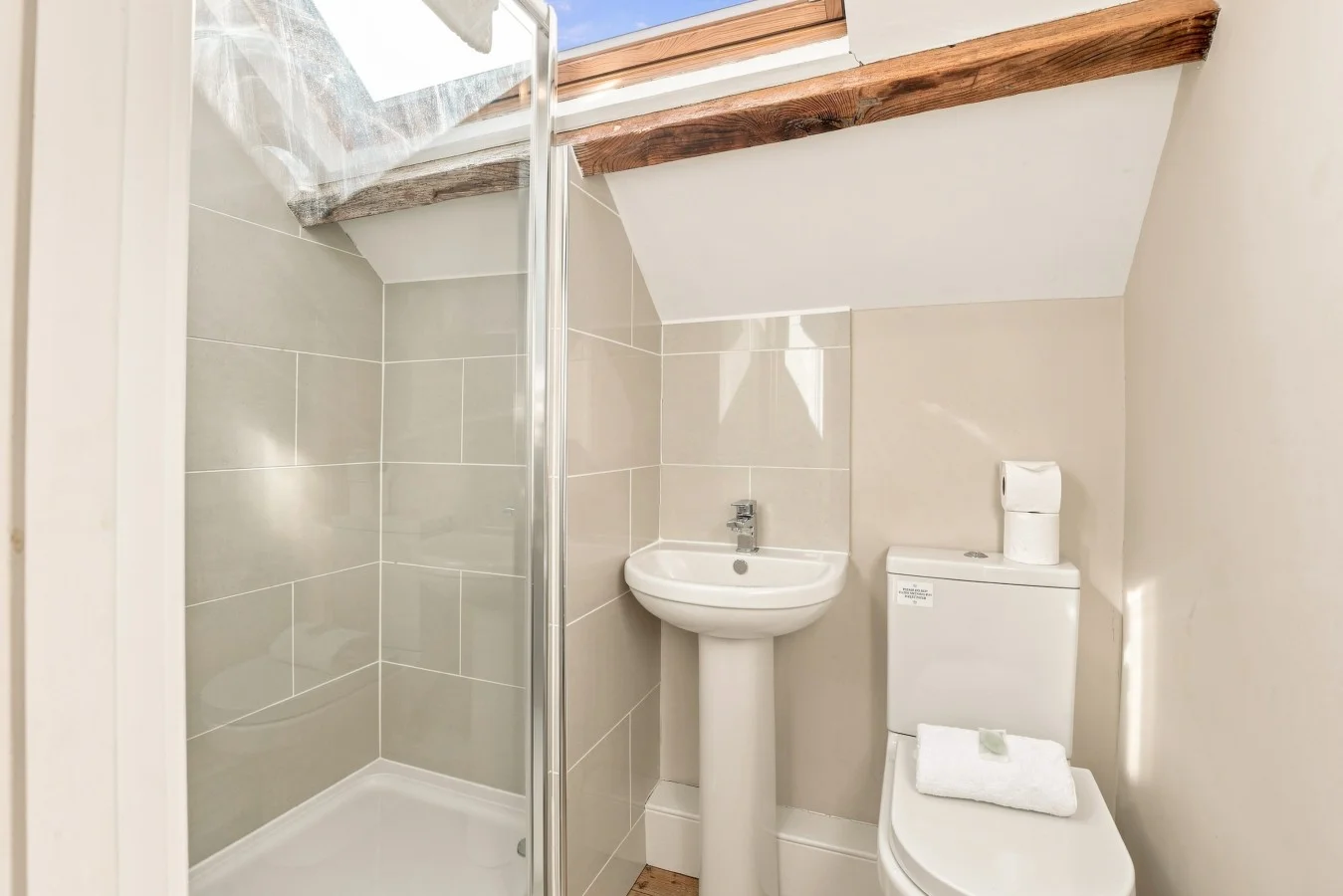 En-suite shower room with skylight, wash basin and WC