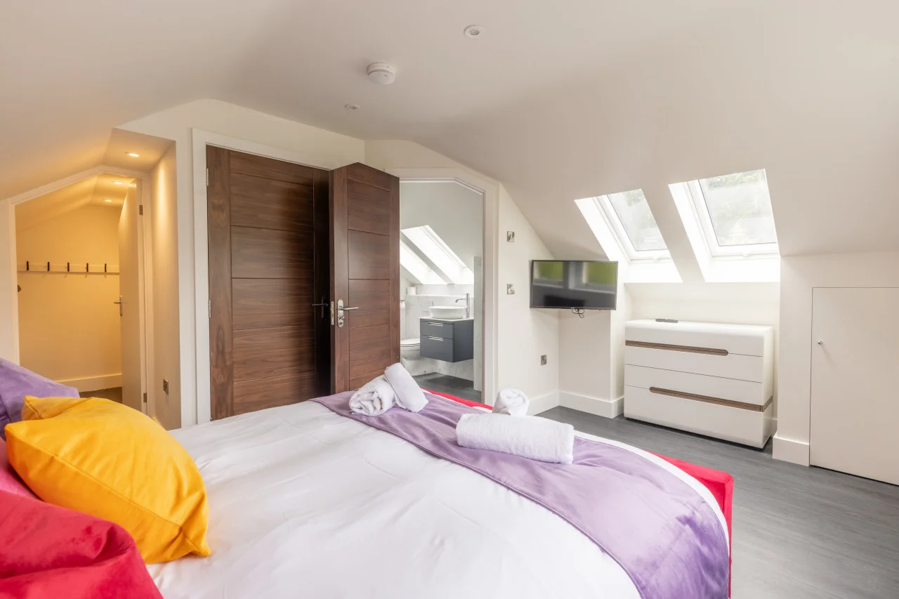 King bedroom with skylights, TV and walk-in wardrobe access