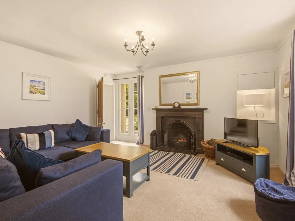 Comfortable living room with open fireplace, Smart TV and plush corner sofa