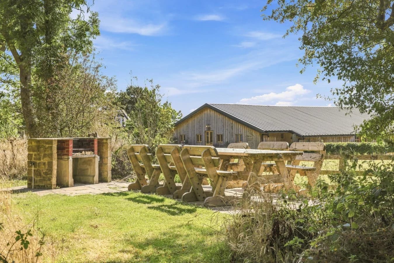 Shared garden with picnic tables, fire-pit area and countryside views