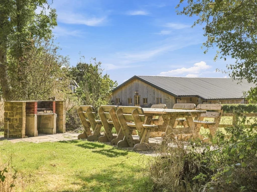 Shared garden with picnic tables, fire-pit area and countryside views
