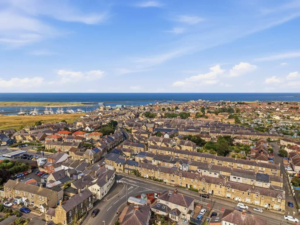 Aerial view of Amble harbour, marina and Northumberland coastline