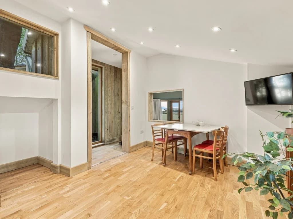 Dining area with Smart TV and natural wood details throughout
