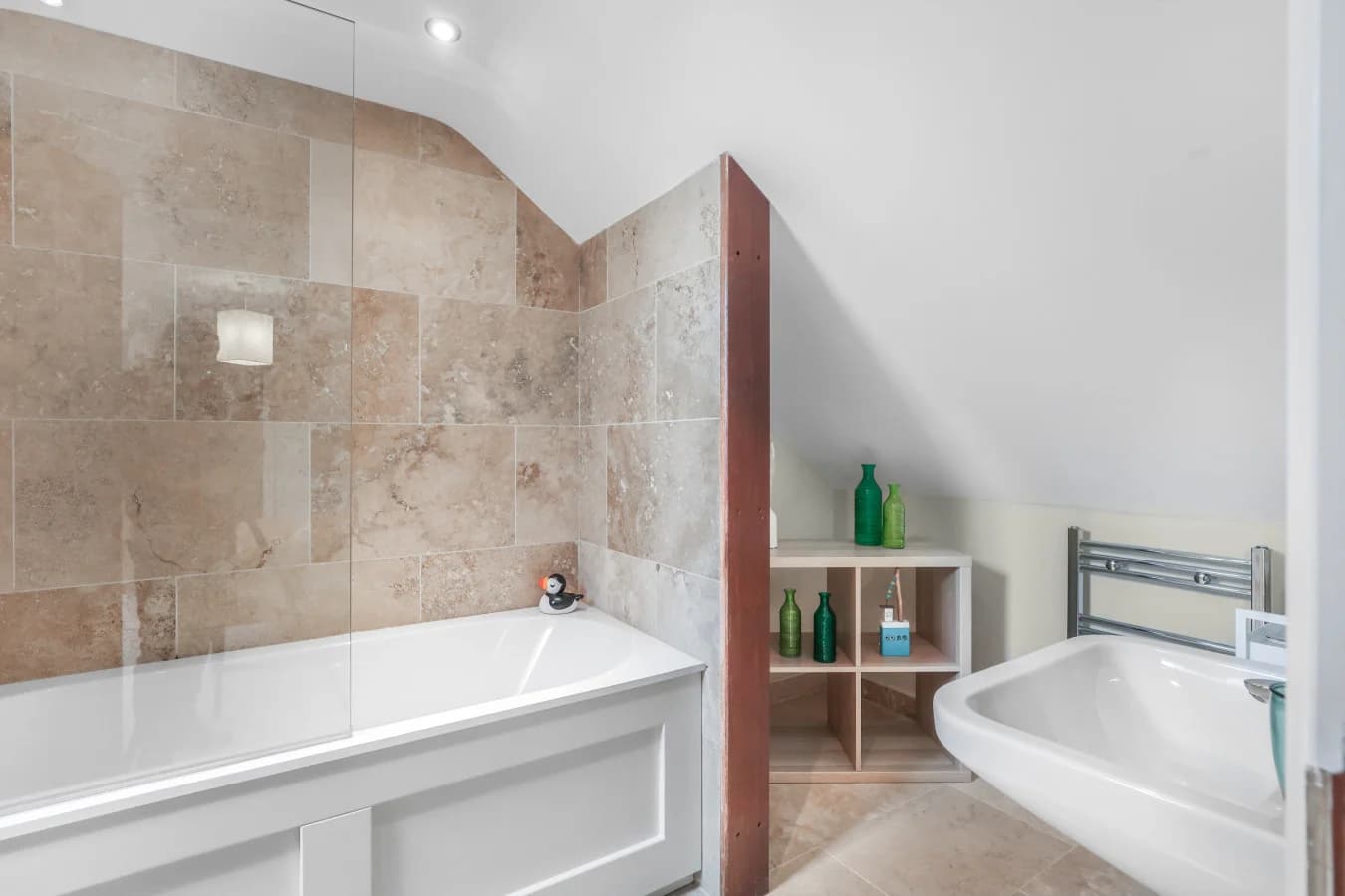 Stylish en-suite with freestanding bath and natural stone finishes