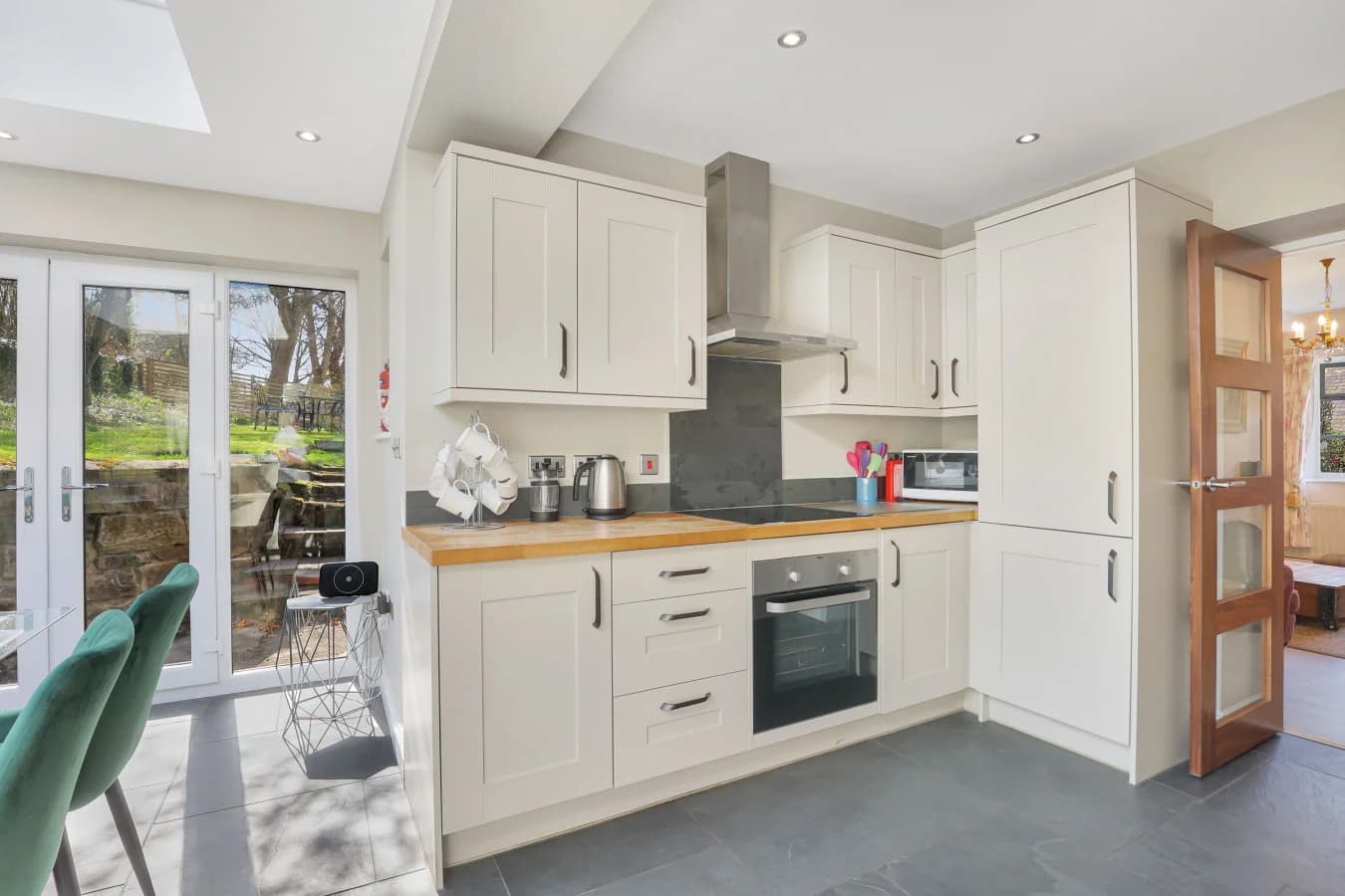 Cream shaker kitchen with garden door and slate floor tiles