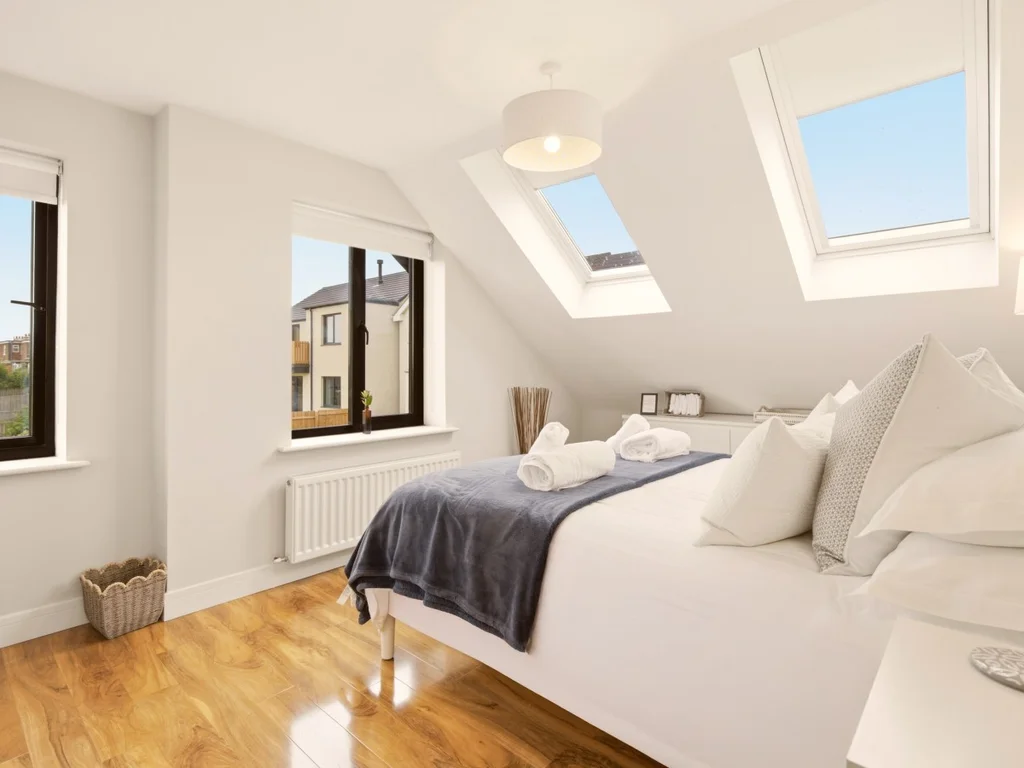 First-floor king bedroom with skylights, oak flooring and dual aspect windows