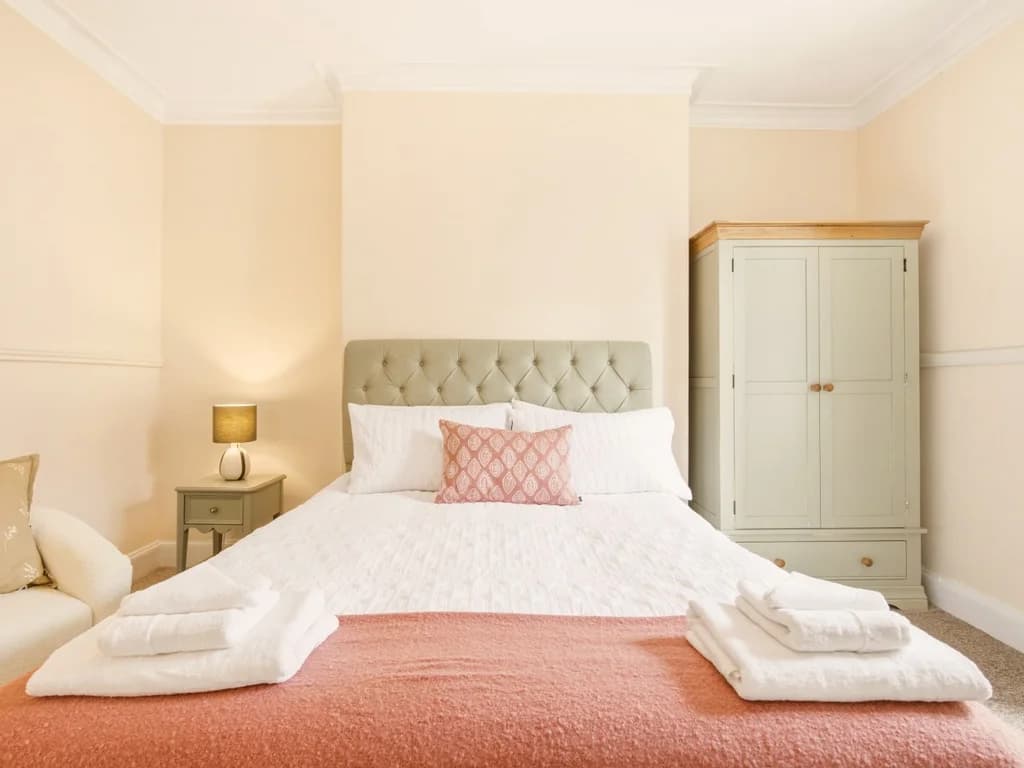 Spacious king bedroom with bedside tables and soft neutral décor.