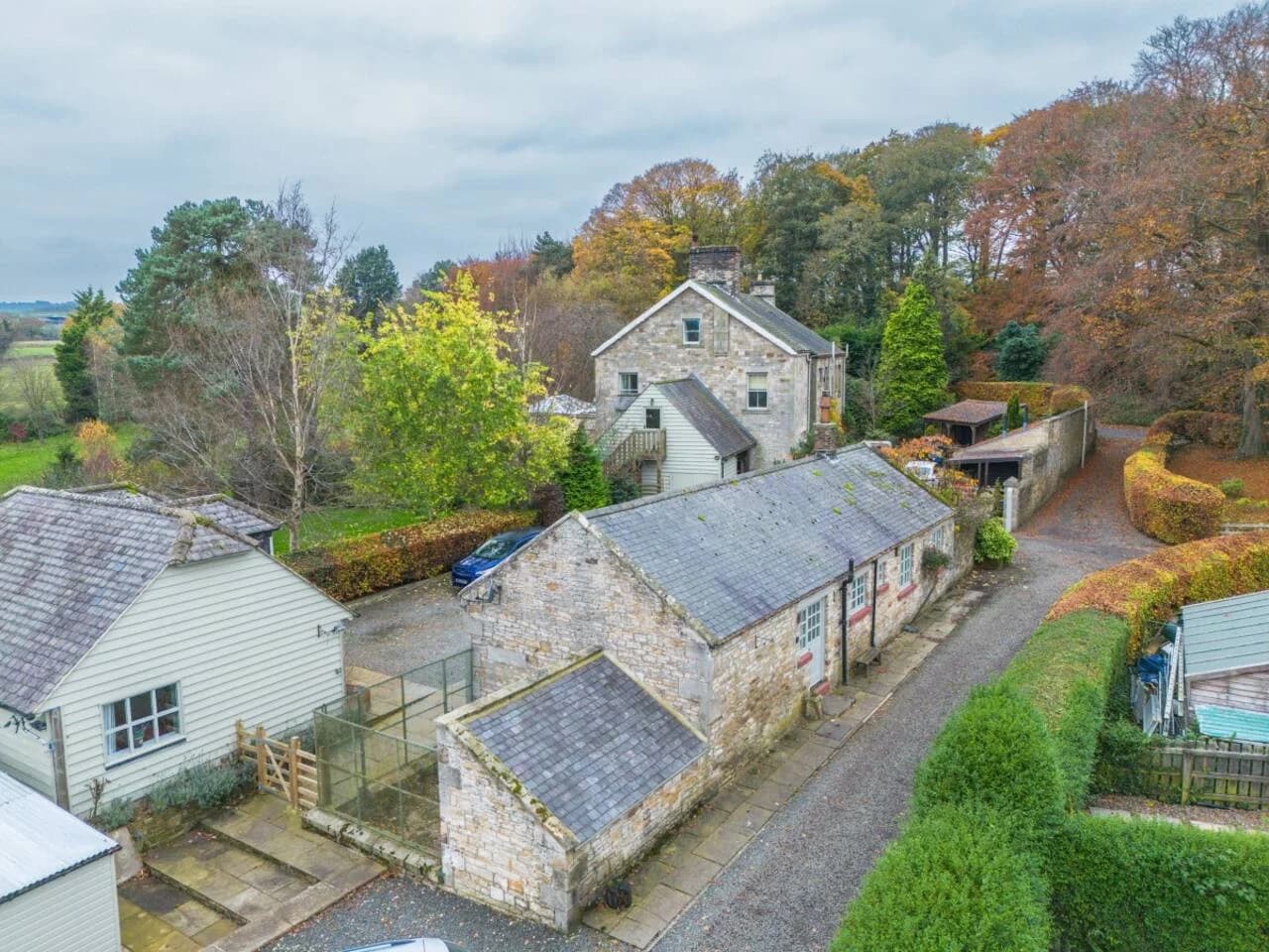 Aerial view showcasing the lodge tucked among mature trees