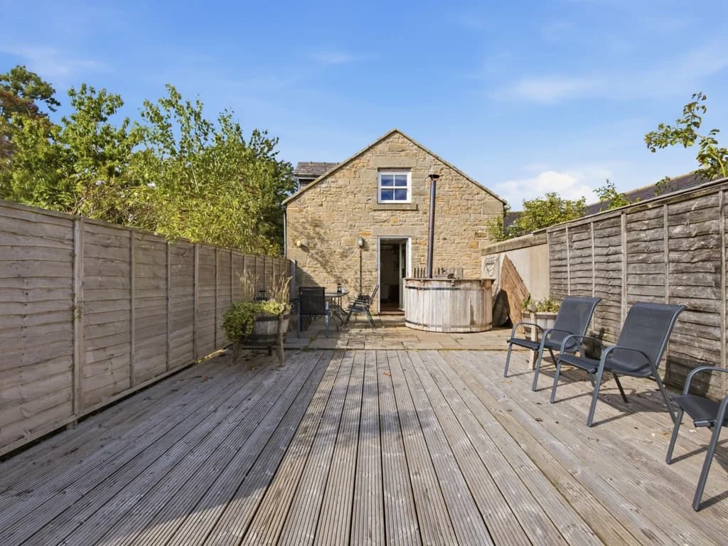 Decked patio with outdoor seating and wood-fired Scandi hot tub