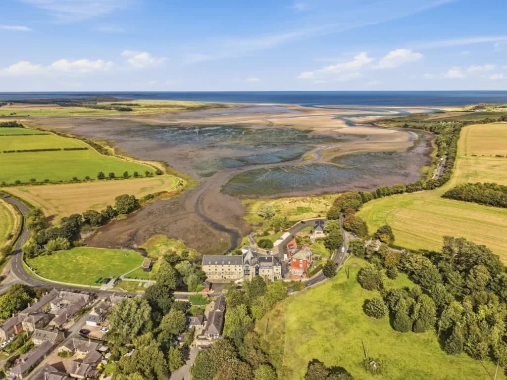 Aerial view across Waren Mill and the sweeping tidal landscape of Budle Bay