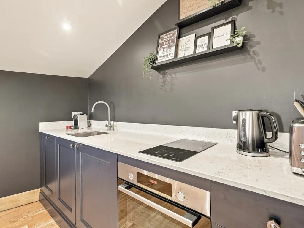 Modern kitchen with induction hob, oven and countertop appliances