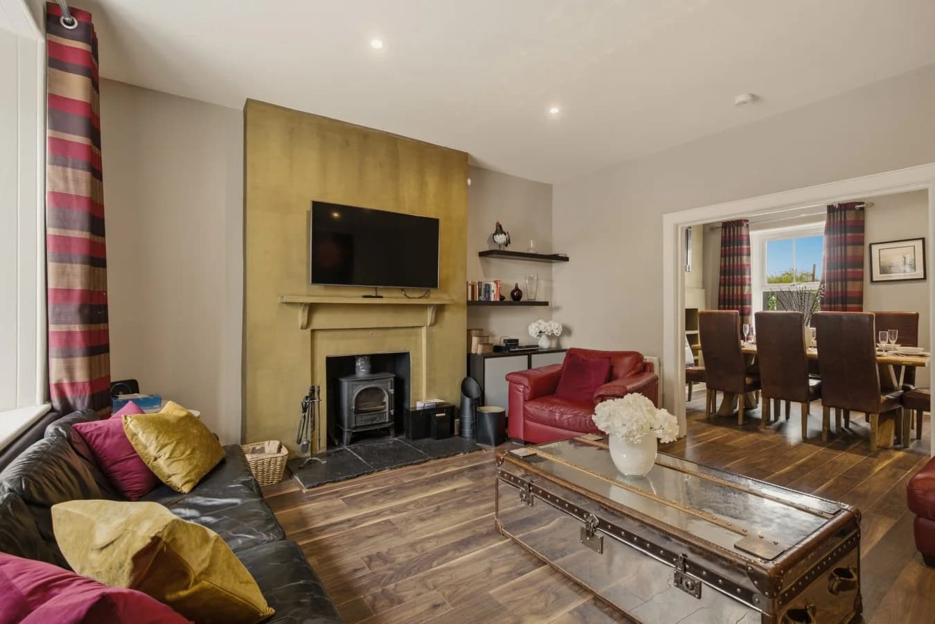 Living room with wood-burning stove and dining area