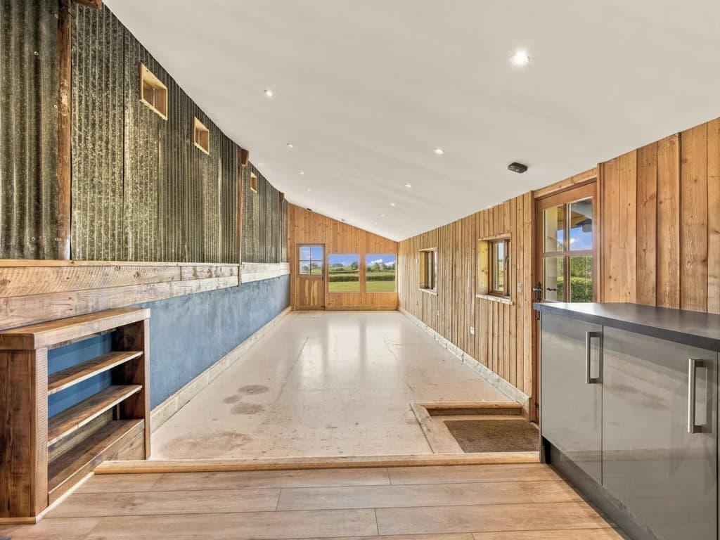Long service area with timber walls, counters and countryside views