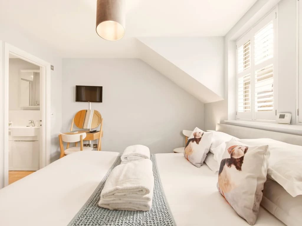 King-size bedroom with Smart TV, dressing table and en-suite access