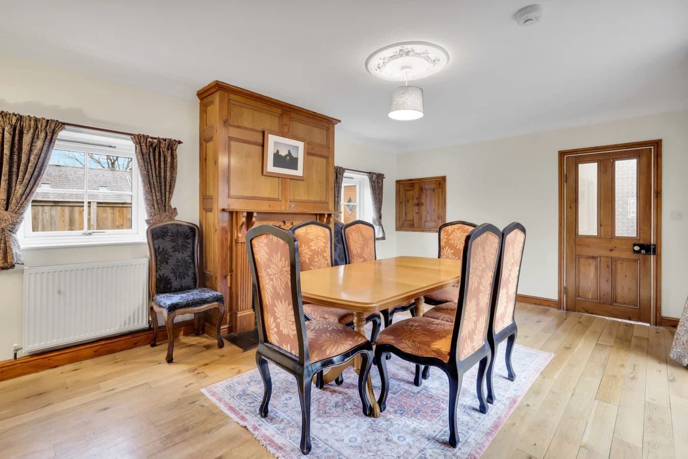Dining space with warm timber floors and traditional styling