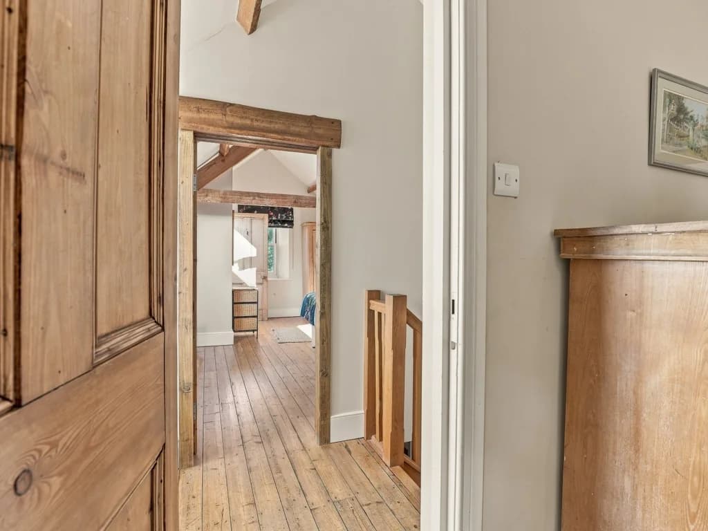 Upper-floor landing with original wooden doors and timber details