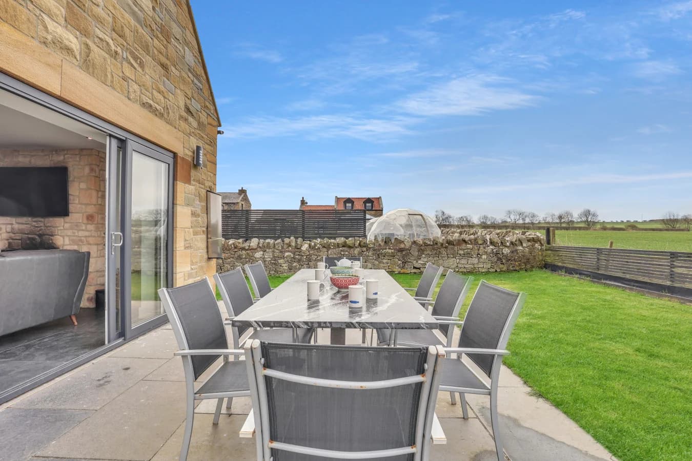 Private patio dining area with peaceful countryside view