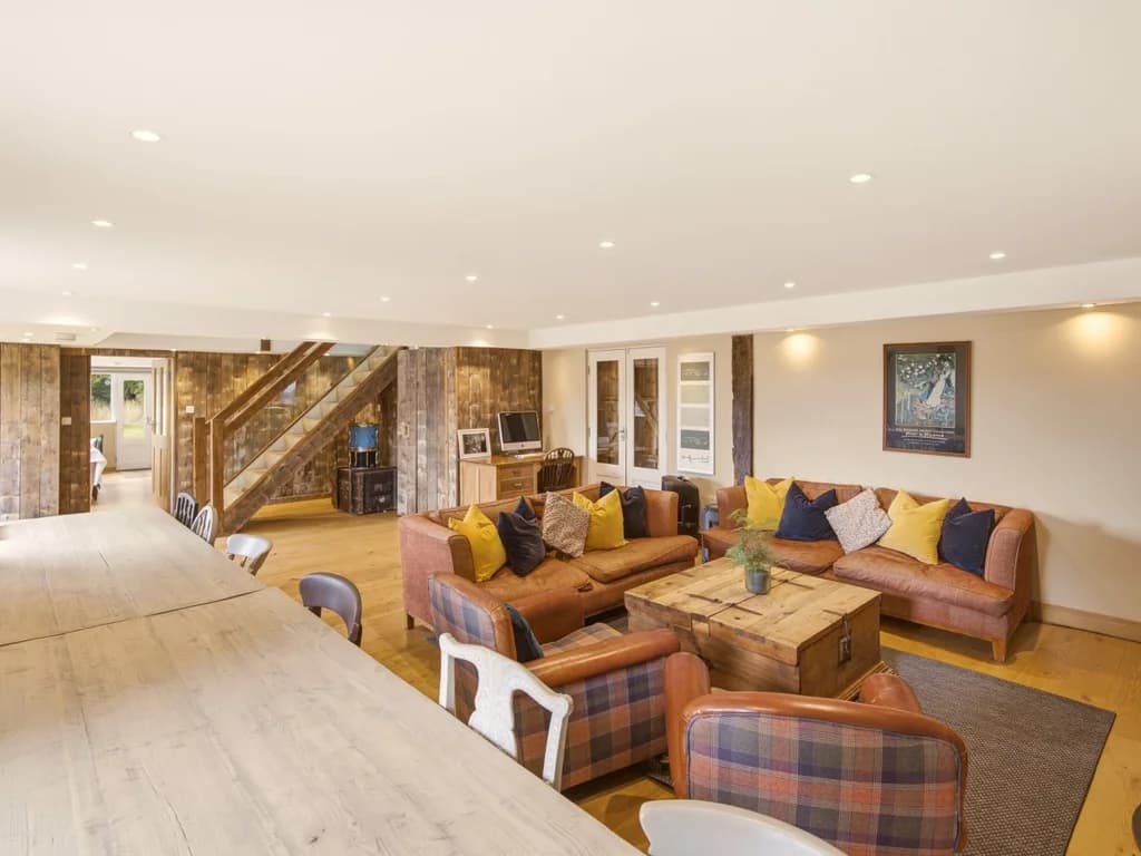 Spacious lounge with generous sofas and rustic wooden coffee table