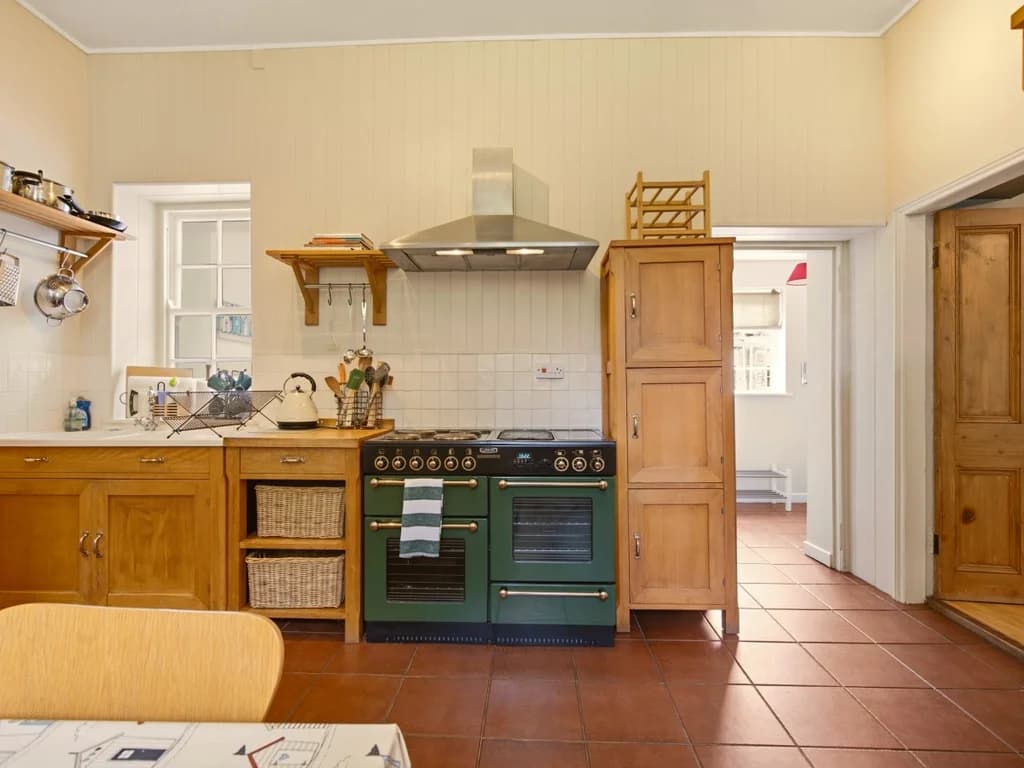Spacious farmhouse kitchen with classic range cooker and solid oak cabinetry