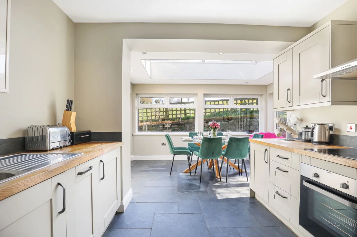 Galley kitchen opening into the bright dining area