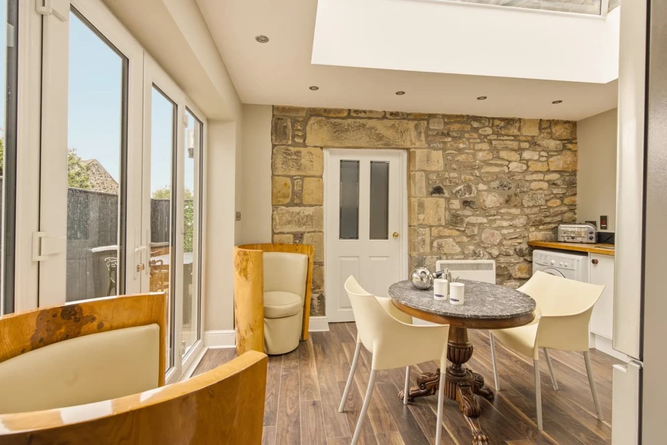 Orangery with exposed stone walls and courtyard access