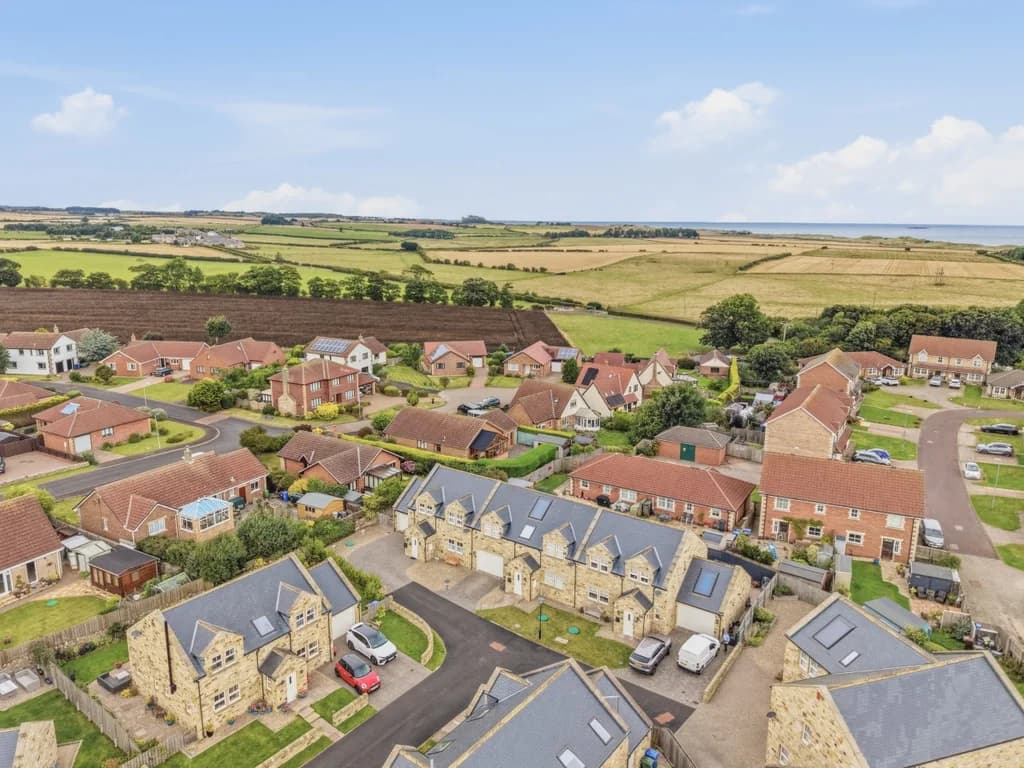 Aerial view over North Sunderland with sweeping countryside towards the coast