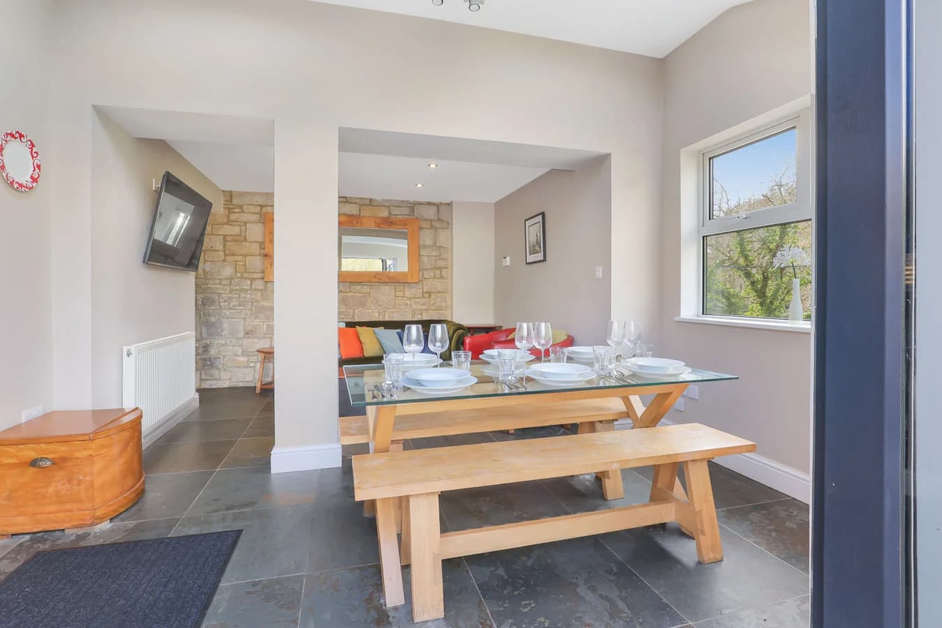 Dining area with wooden picnic-style table and slate flooring