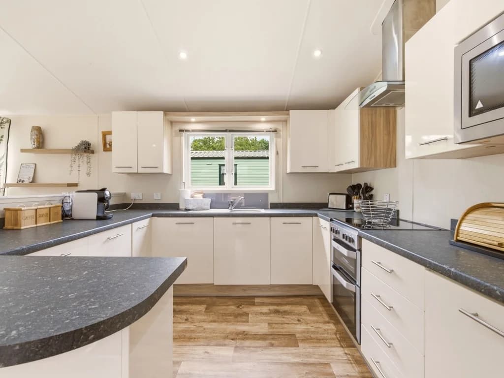 Spacious kitchen with ample cabinetry, oven, microwave and breakfast bar