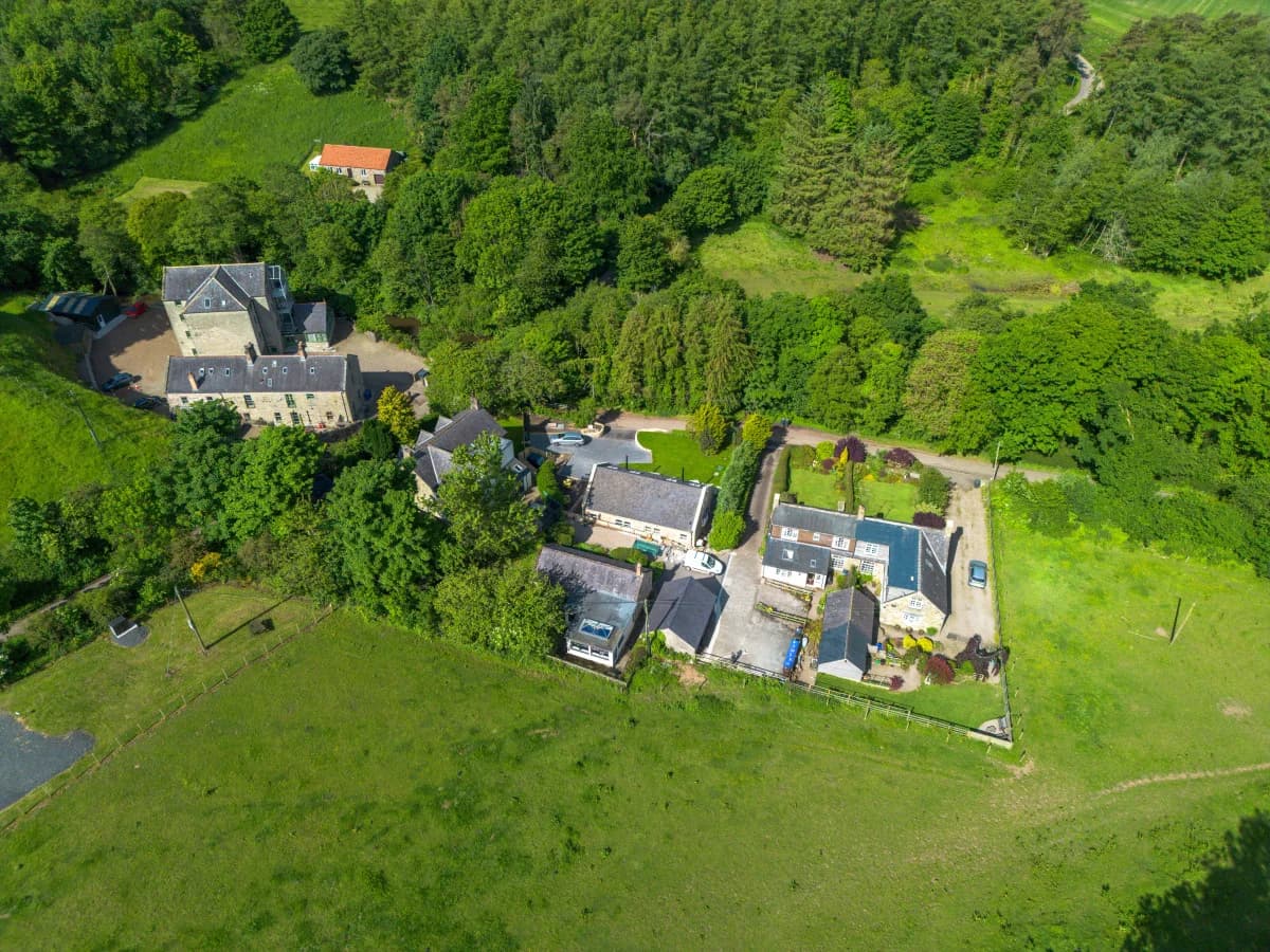 Aerial view of the Spindlestone cottage complex and woodland surroundings