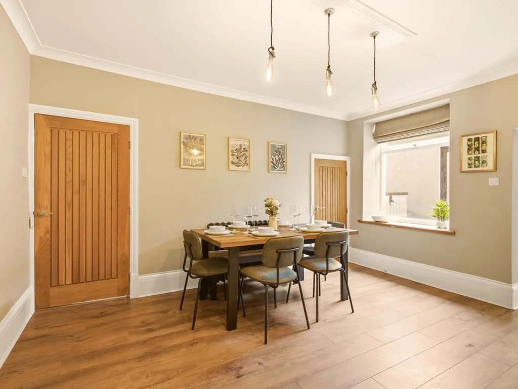 Dining area with seating for six leading through to the kitchen.