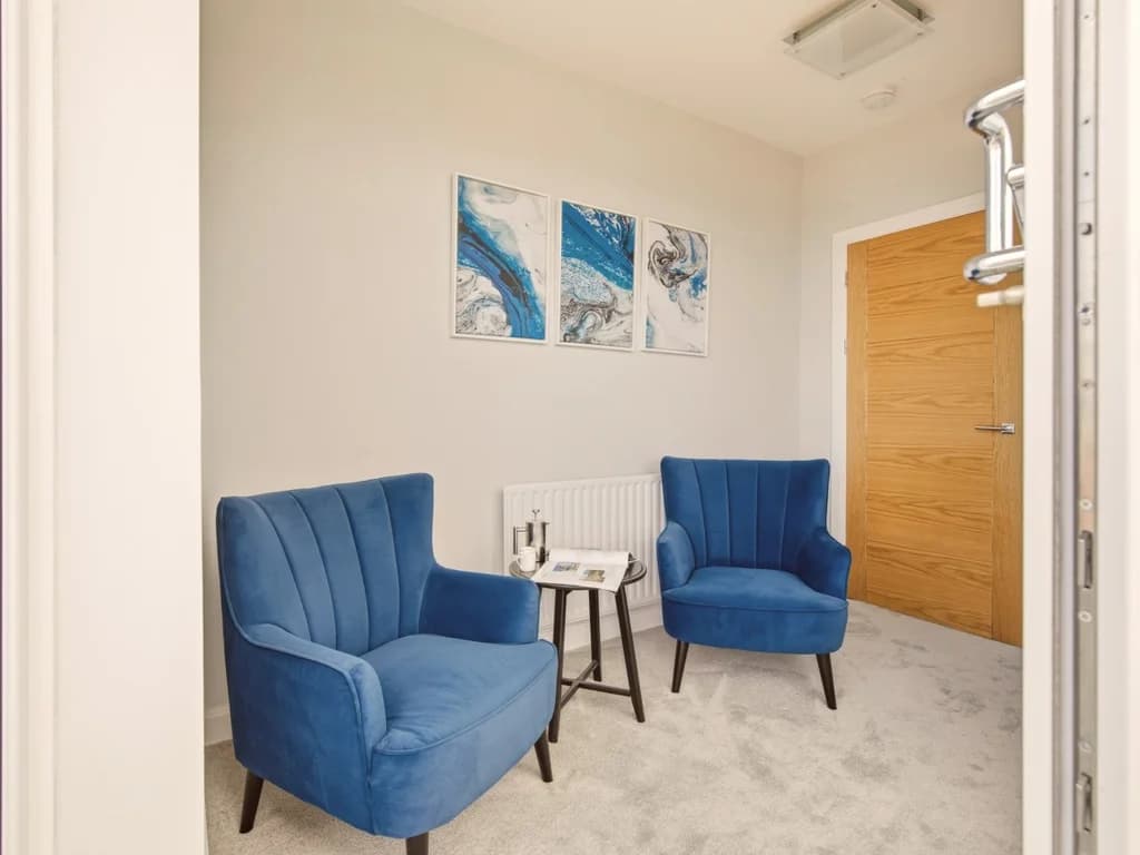 Peaceful reading nook with comfortable seating beside the balcony and sea views