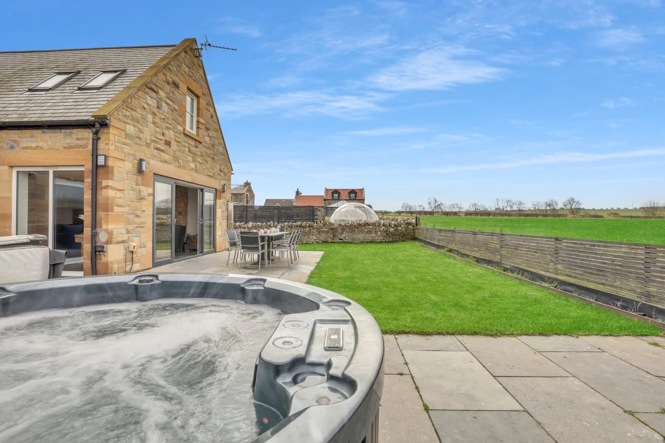 Private hot tub and enclosed garden with open countryside view