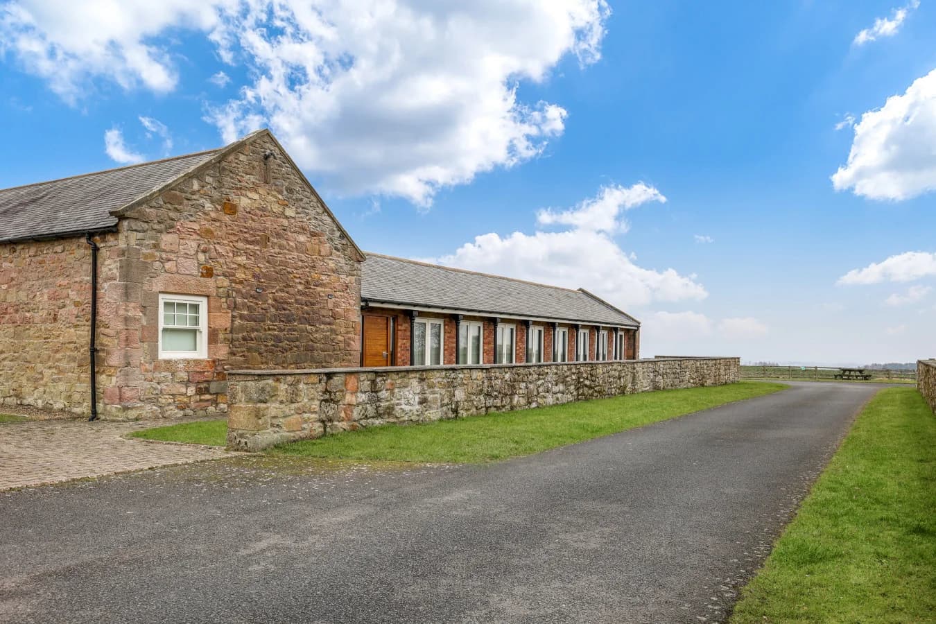Exterior view of The Coach House with stone walls and driveway