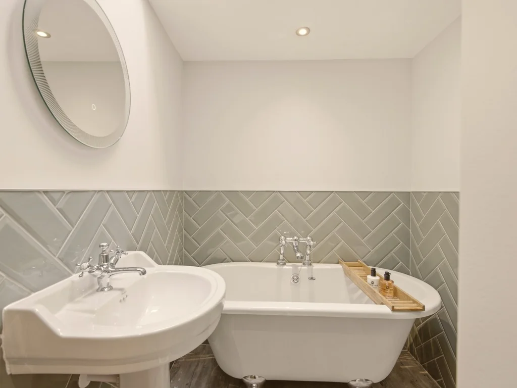 Contemporary family bathroom with freestanding bath and stylish herringbone tiles