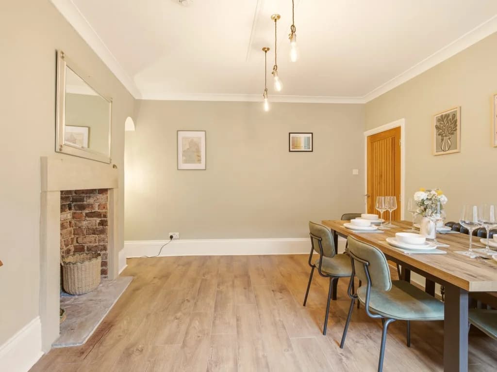 Spacious dining room with feature fireplace and contemporary dining space.
