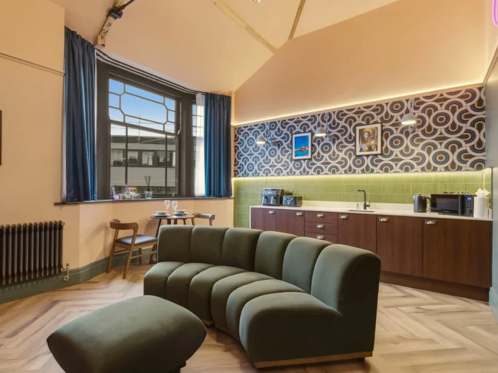 Open-plan lounge, kitchen and dining area with large bay window.