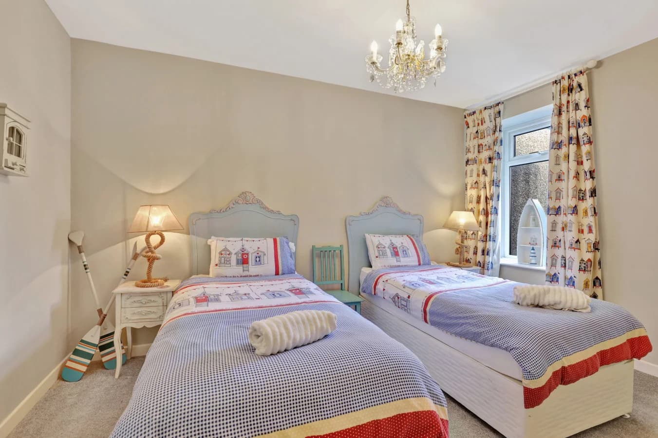 Bright twin room with matching beds and feature chandelier
