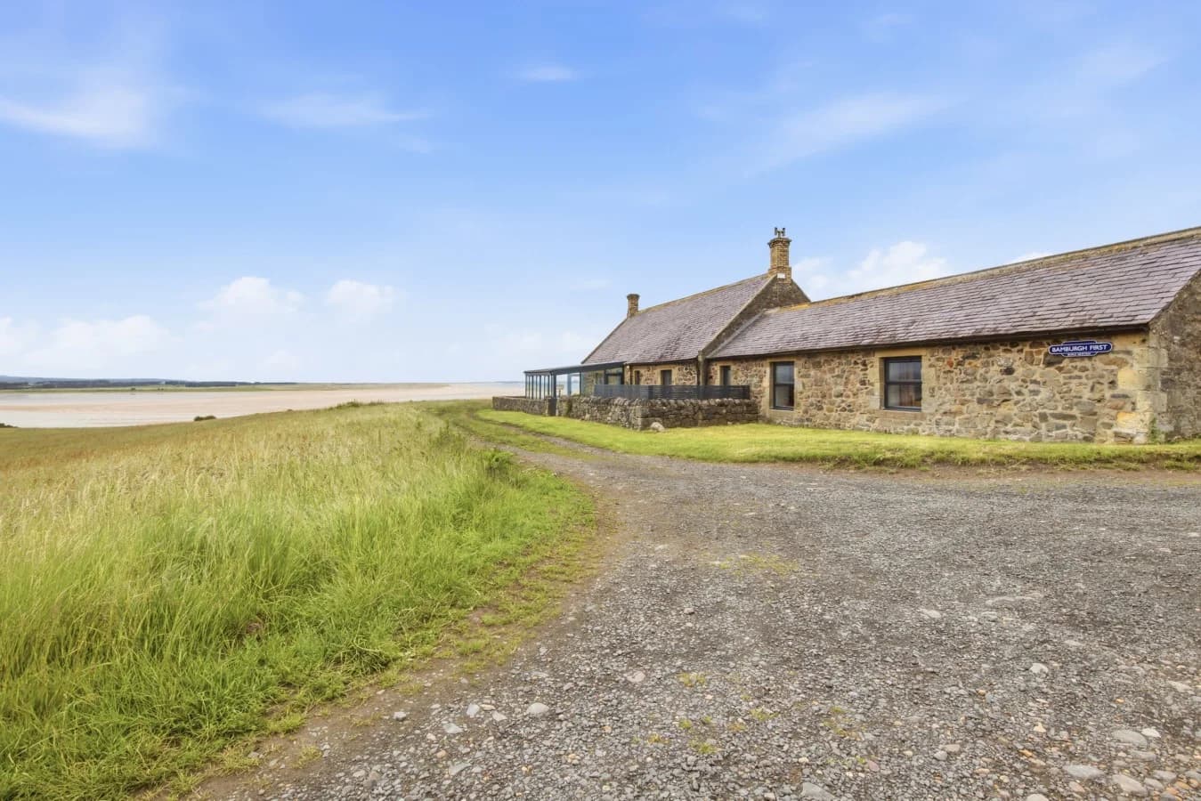 Stone cottage beside Budle Bay with sweeping coastal surroundings