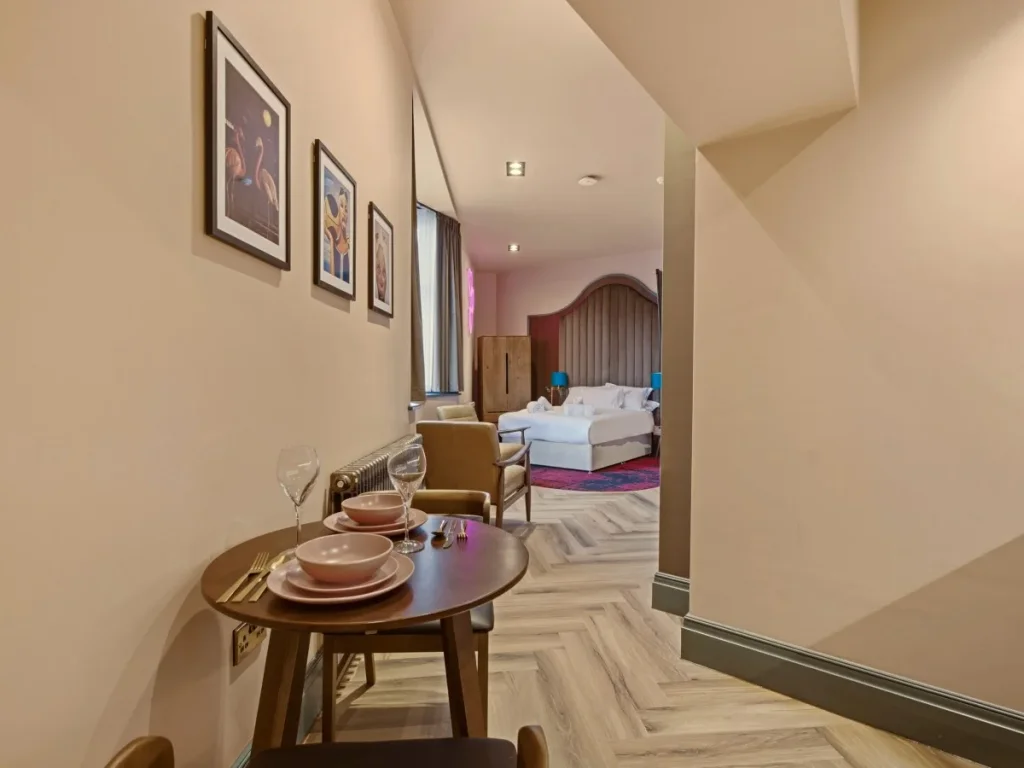 Dining area set for two with the open-plan sleeping space beyond.