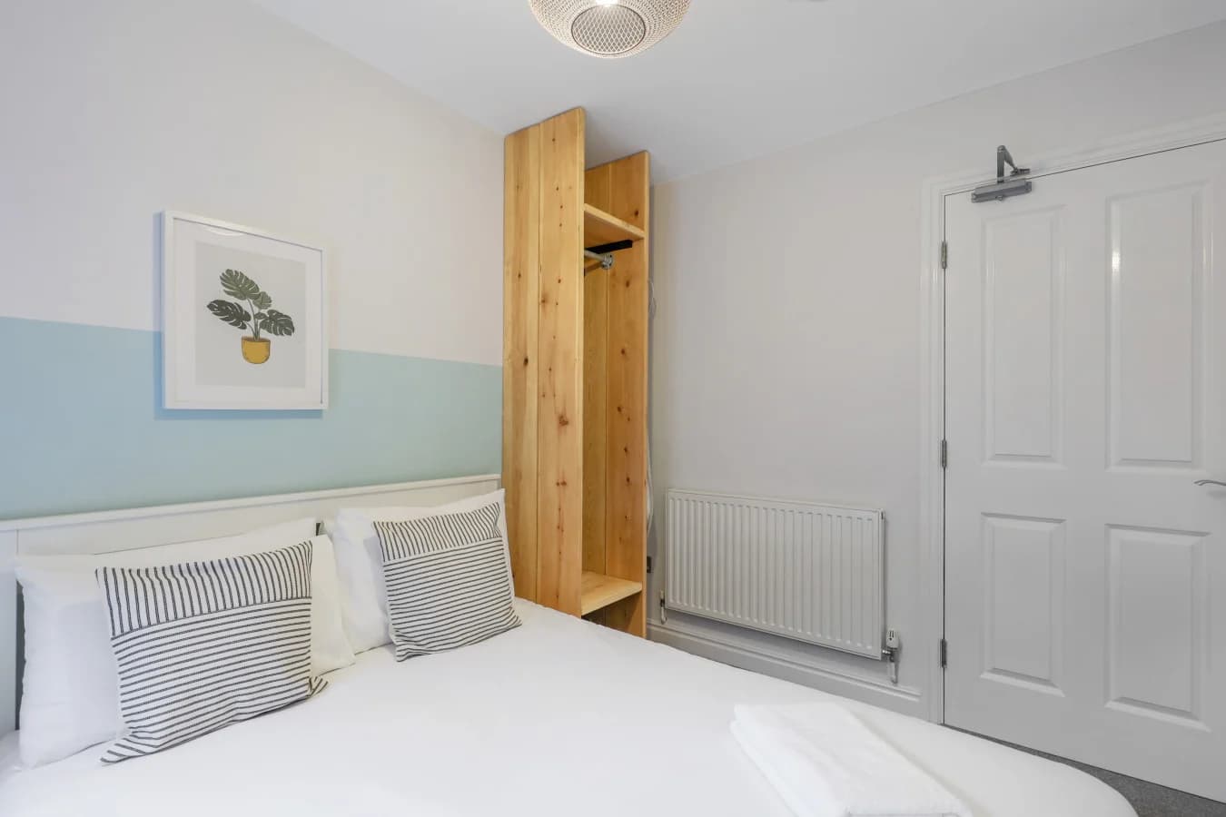 Calm and inviting bedroom with panelled detailing and contemporary furnishings