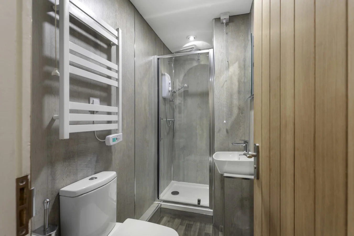 Contemporary shower room with heated towel rail and grey finishes