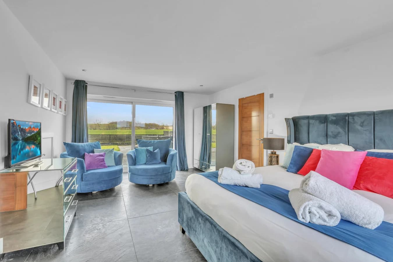 Luxurious super-king bedroom with seating area and garden view