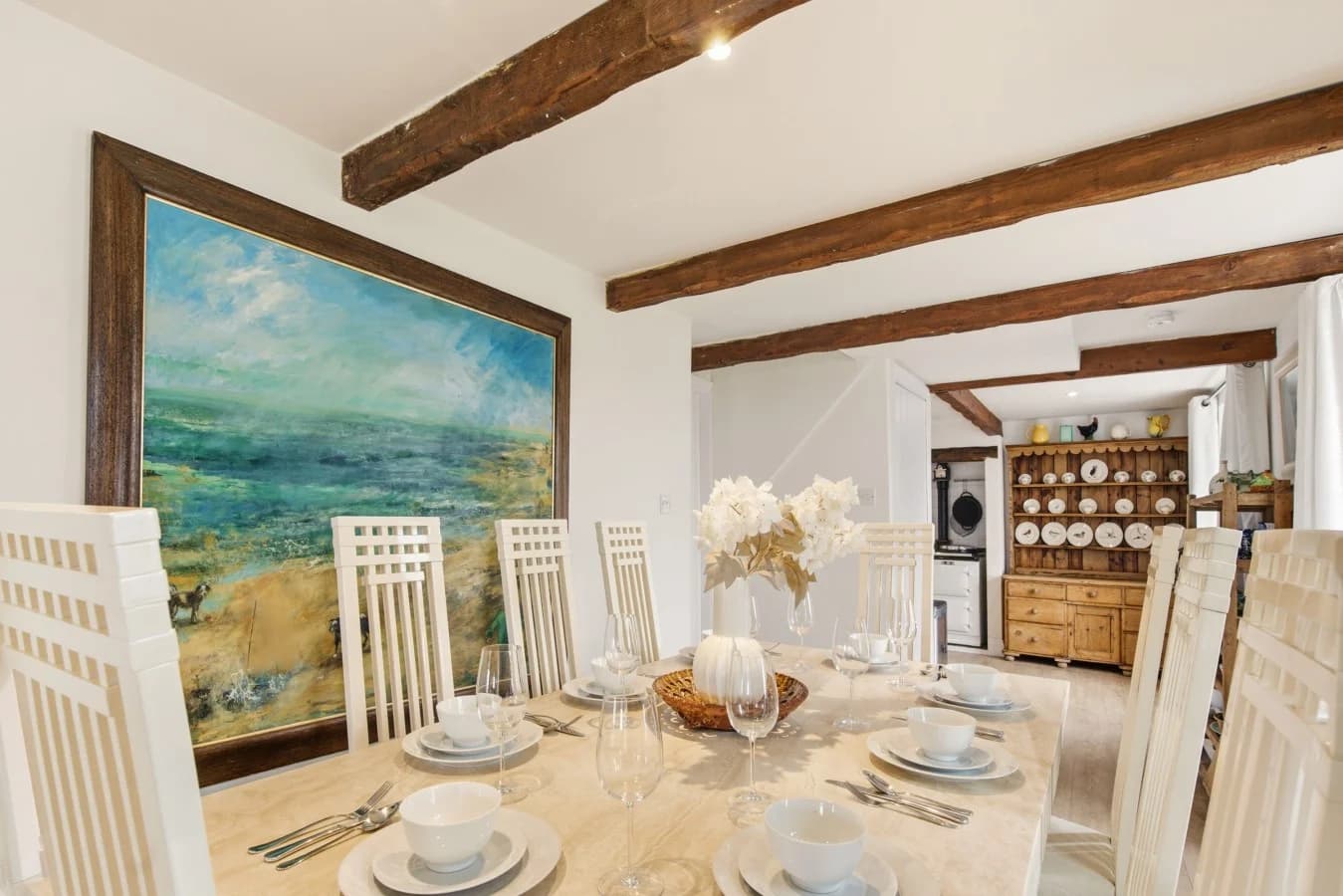 Dining table for eight with exposed beams and oak flooring