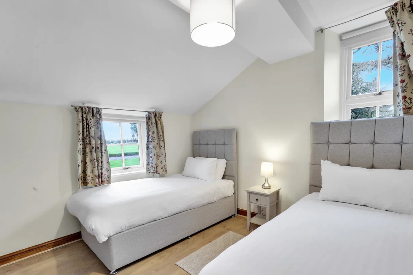 Twin bedroom tucked beneath the eaves with countryside views